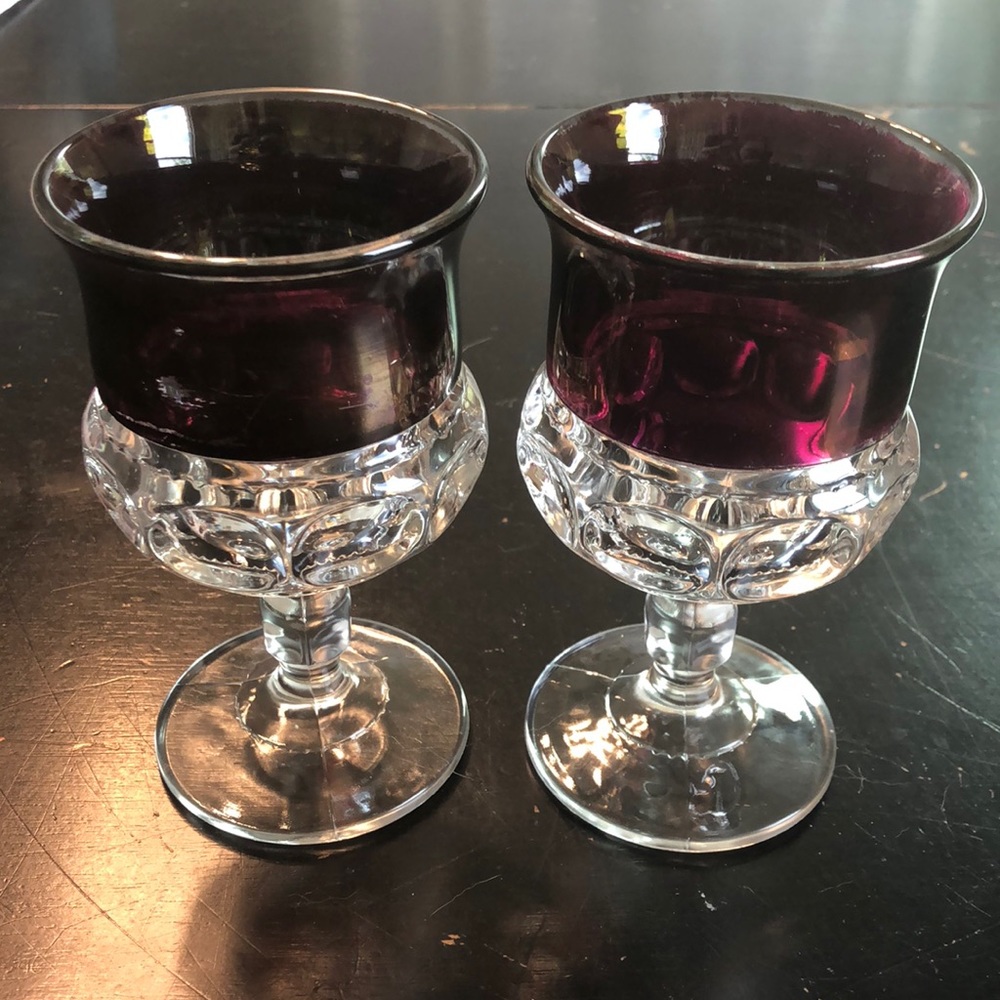 Pair of King’s Crown wine glasses with thumbprint stem in cranberry. 1950s